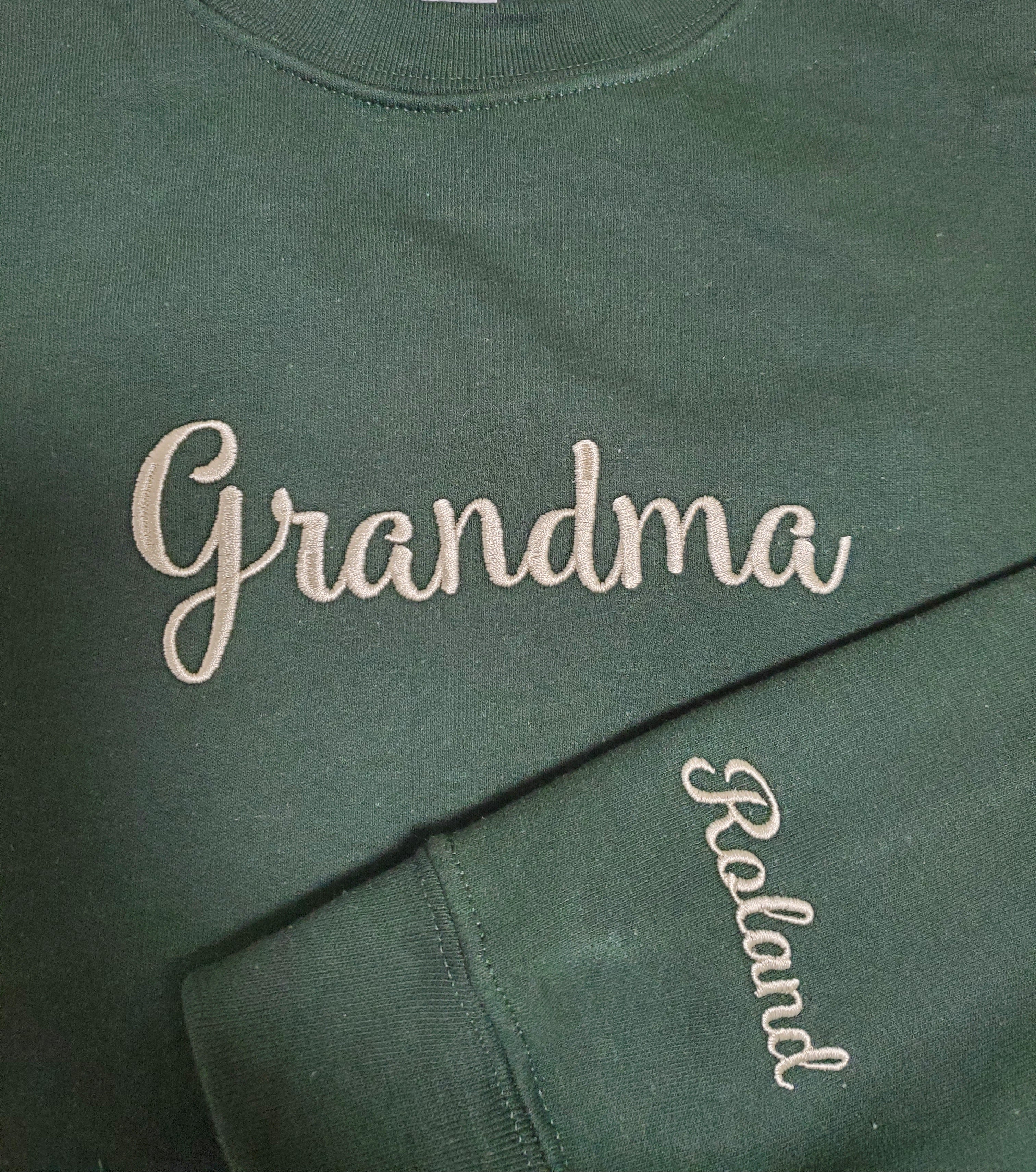 Green sweatshirt with 'Grandma' and 'Roland' embroidered on it.